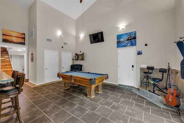 rec room with pool table, high vaulted ceiling, and dark tile patterned flooring