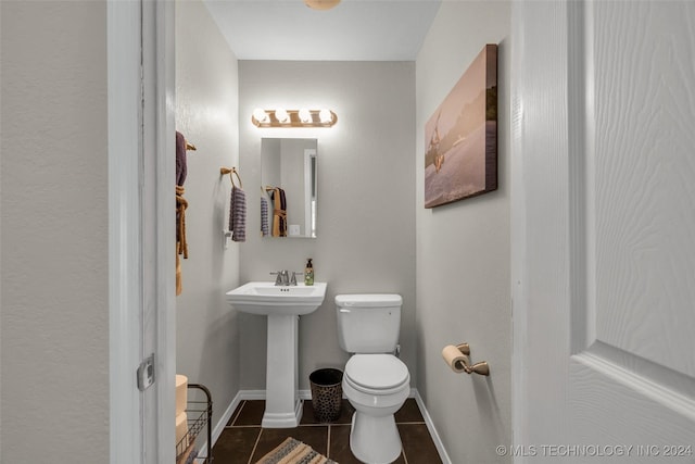 bathroom with tile patterned flooring, toilet, and sink