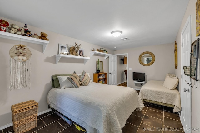 bedroom with dark tile patterned flooring