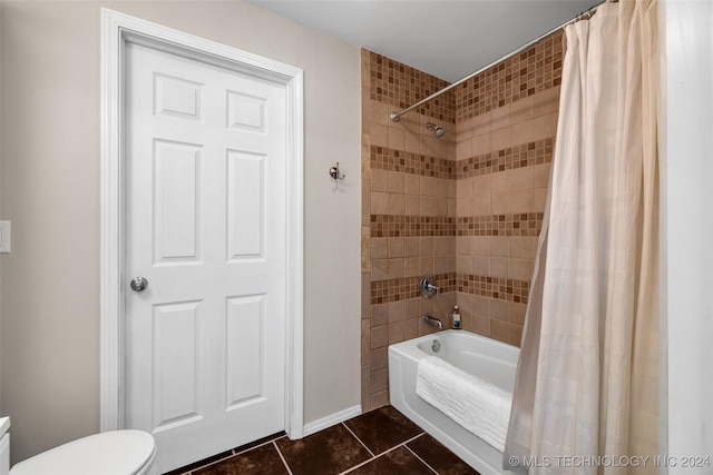 bathroom with toilet, shower / bath combo, and tile patterned floors