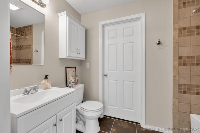 bathroom featuring tile patterned flooring, vanity, toilet, and tiled shower