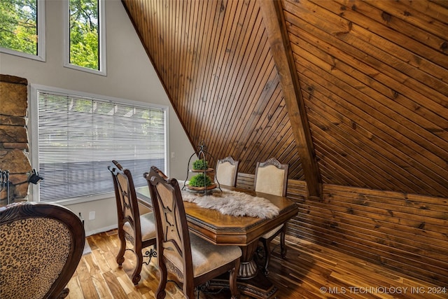 dining space with wood-type flooring and lofted ceiling