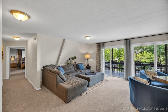 living room featuring light carpet and a textured ceiling