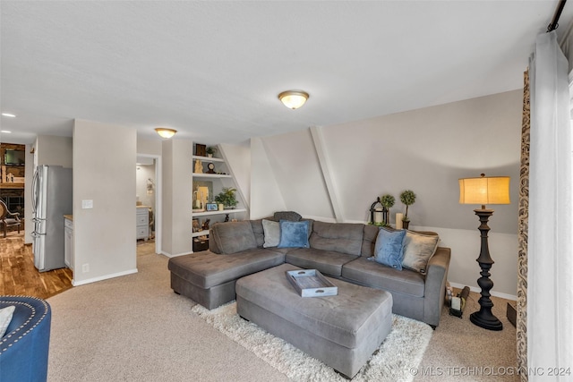 living room featuring carpet flooring and built in features