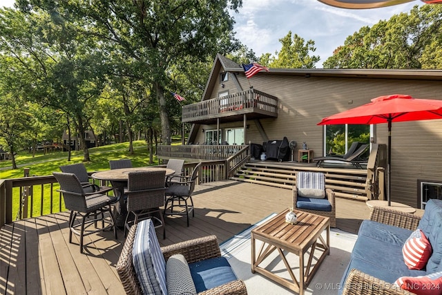 deck with a lawn, area for grilling, and an outdoor living space