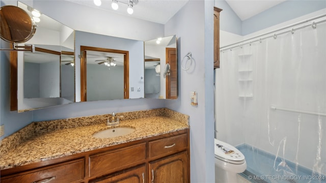 bathroom featuring ceiling fan, vanity, toilet, walk in shower, and vaulted ceiling