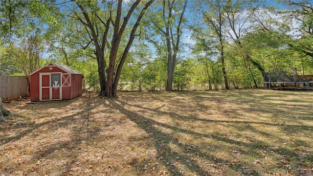 view of yard with a storage unit and a trampoline