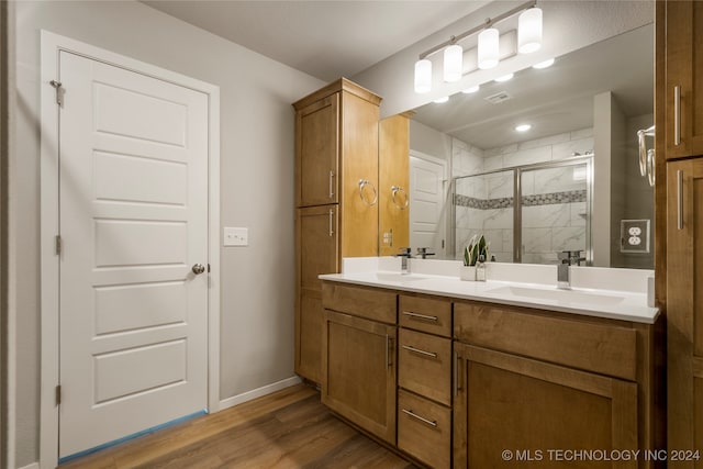 bathroom featuring vanity, a shower with shower door, and hardwood / wood-style flooring