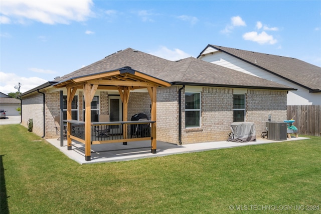 back of property with a patio, a gazebo, central air condition unit, and a yard