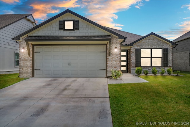 view of front of home featuring a lawn and a garage