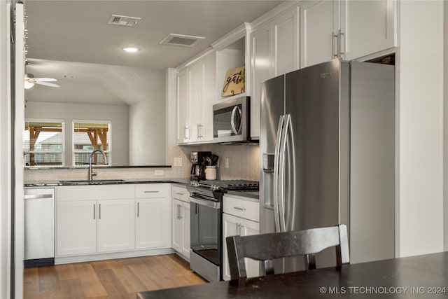 kitchen featuring ceiling fan, sink, light hardwood / wood-style flooring, white cabinetry, and stainless steel appliances