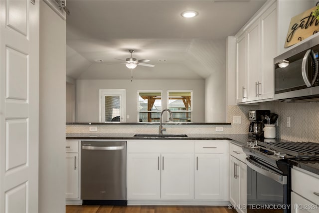 kitchen with white cabinets, appliances with stainless steel finishes, and sink