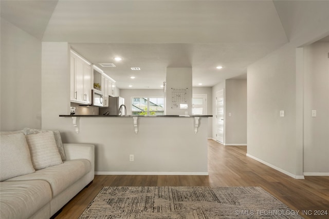 unfurnished living room with dark wood-type flooring