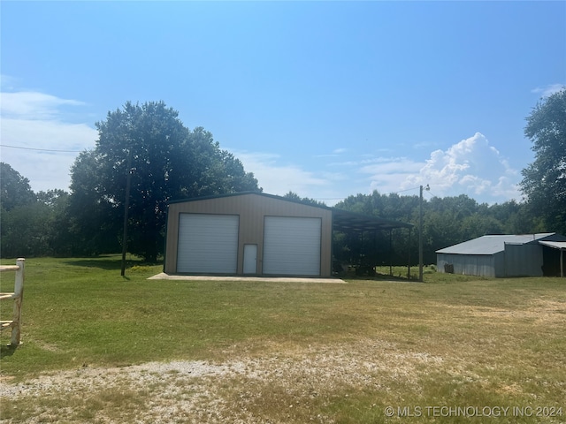 view of outbuilding with a garage and a lawn