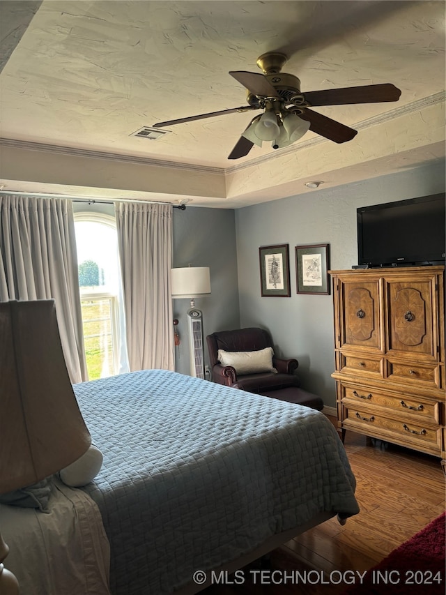 bedroom with hardwood / wood-style flooring and ceiling fan