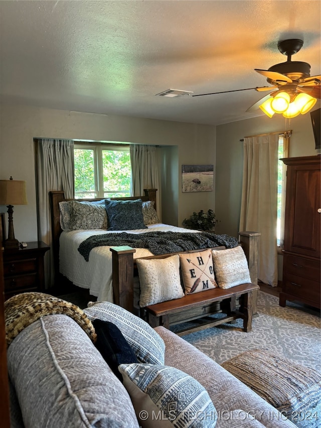 bedroom with a textured ceiling and ceiling fan