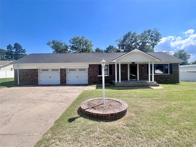 ranch-style house with a garage and a front lawn