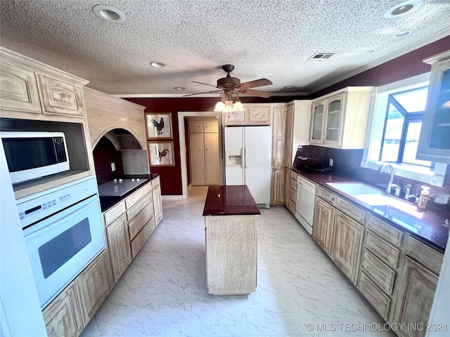 kitchen featuring ornamental molding, white appliances, a kitchen island, and ceiling fan