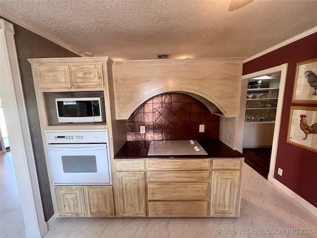 kitchen with light wood-type flooring, white appliances, light brown cabinetry, and ornamental molding