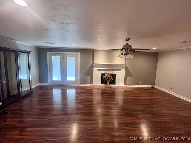 unfurnished living room featuring crown molding, ceiling fan, a high end fireplace, and dark hardwood / wood-style flooring