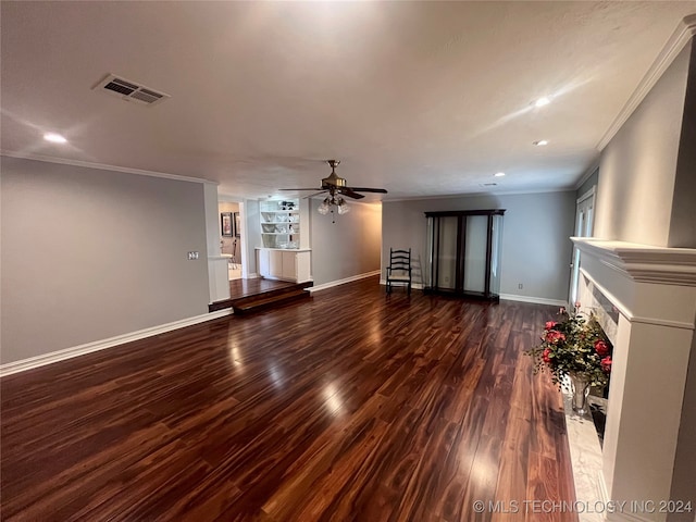 unfurnished living room with dark wood-type flooring, ceiling fan, a high end fireplace, and ornamental molding