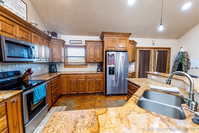 kitchen featuring decorative backsplash, pendant lighting, sink, stainless steel appliances, and lofted ceiling