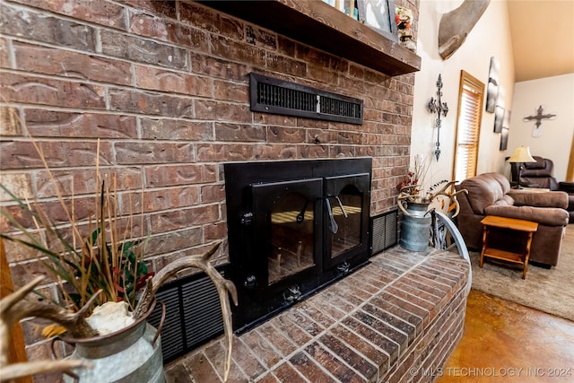 living room with a fireplace and concrete floors