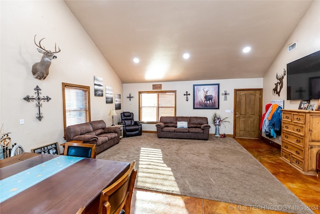 living room with high vaulted ceiling