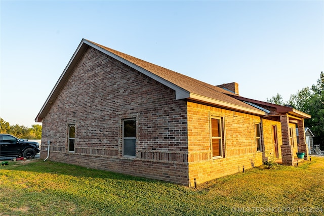 view of side of home featuring a yard