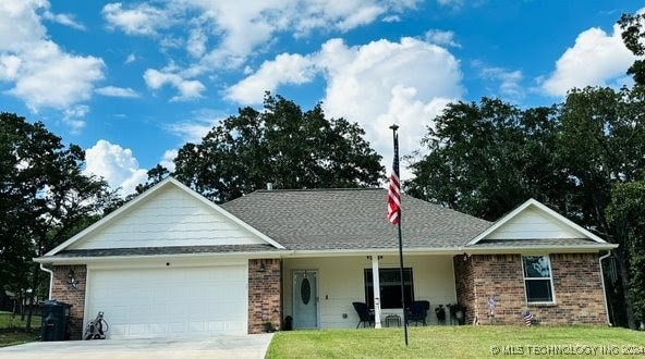 ranch-style home featuring a front yard and a garage