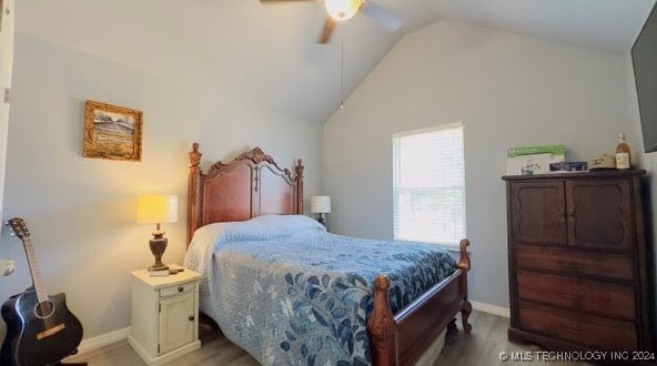 bedroom with vaulted ceiling, light hardwood / wood-style flooring, and ceiling fan