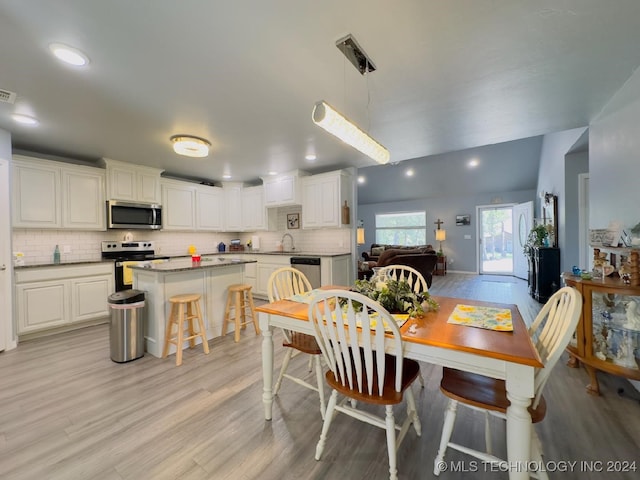 dining space featuring sink and light hardwood / wood-style flooring