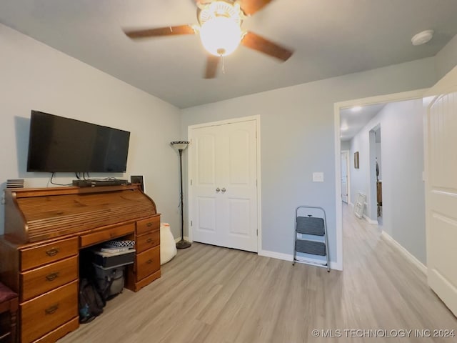 home office with light wood-type flooring and ceiling fan