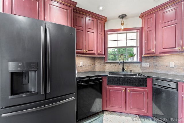 kitchen featuring stainless steel fridge, dishwasher, sink, decorative backsplash, and dark stone counters