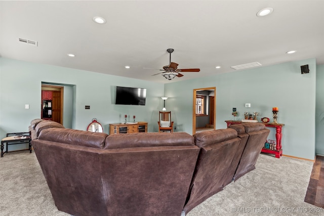 carpeted living room featuring ceiling fan