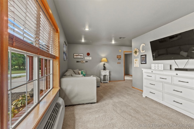 carpeted living room featuring a baseboard radiator