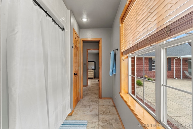 hall featuring light tile patterned flooring