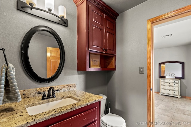 bathroom featuring vanity, toilet, and tile patterned floors