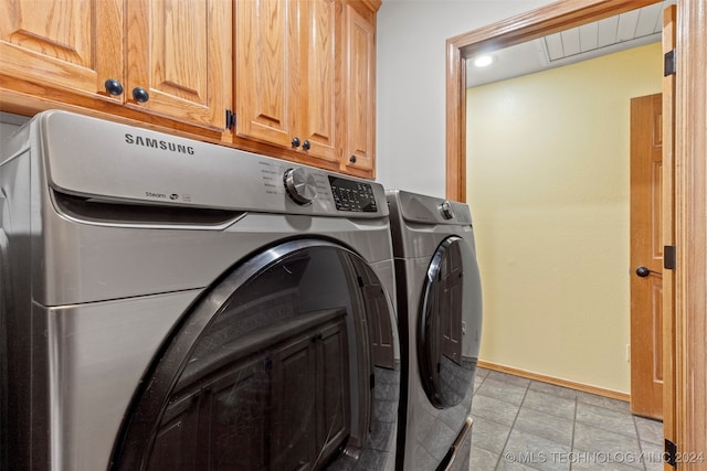 clothes washing area featuring cabinets, separate washer and dryer, and light tile patterned flooring