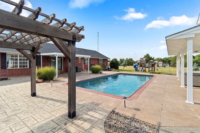 view of swimming pool with central air condition unit, a patio, and a pergola