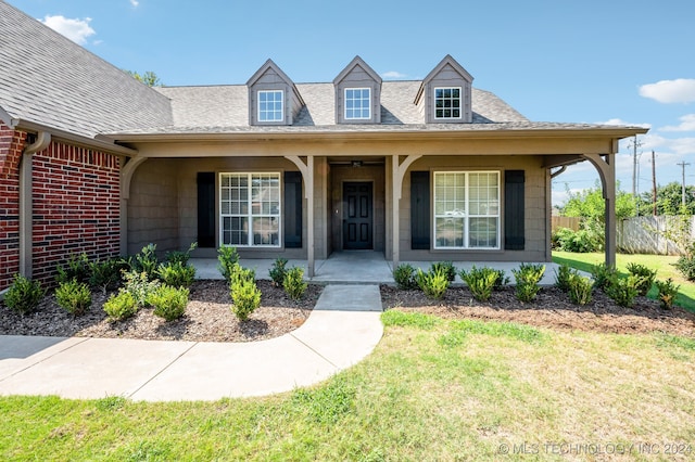 view of front of home featuring a porch and a front lawn