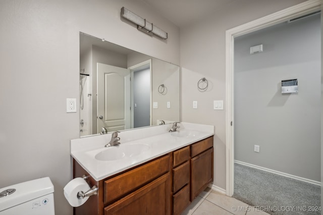 bathroom featuring tile patterned flooring, vanity, and toilet