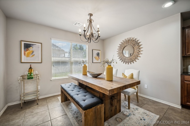 dining area featuring a chandelier and tile patterned floors