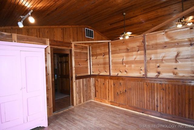 unfurnished room with hardwood / wood-style flooring, wood walls, wooden ceiling, and vaulted ceiling