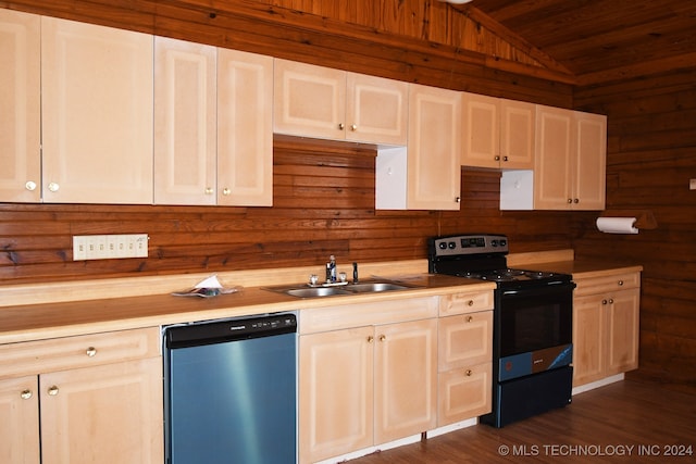 kitchen featuring sink, wooden walls, vaulted ceiling, stainless steel dishwasher, and black range with electric cooktop