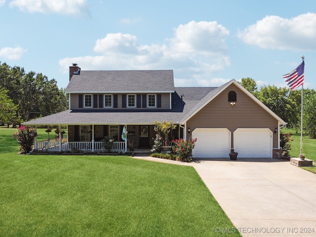 view of front of house featuring covered porch, a garage, and a front yard