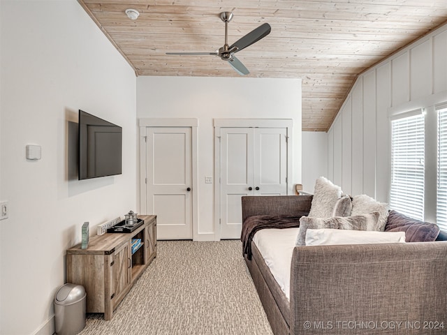 carpeted living room featuring ceiling fan, vaulted ceiling, and wooden ceiling