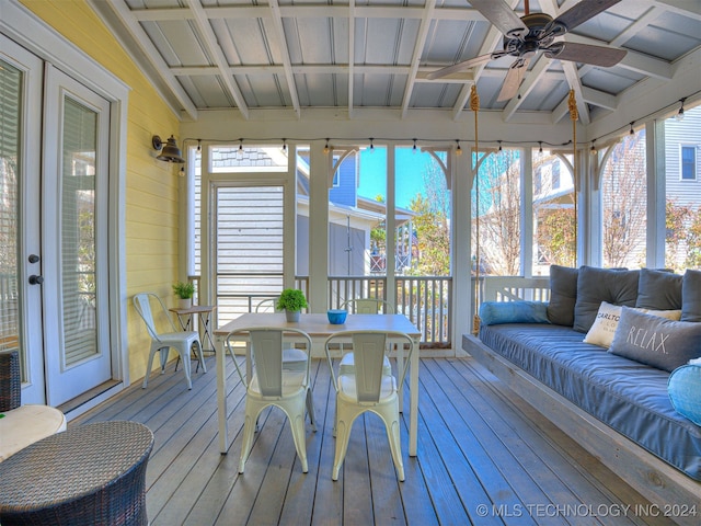 sunroom / solarium with coffered ceiling, plenty of natural light, ceiling fan, and vaulted ceiling with beams