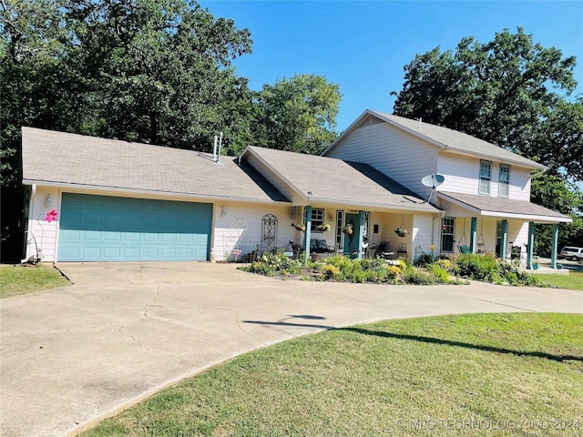 view of front of home featuring a porch, a garage, and a front lawn