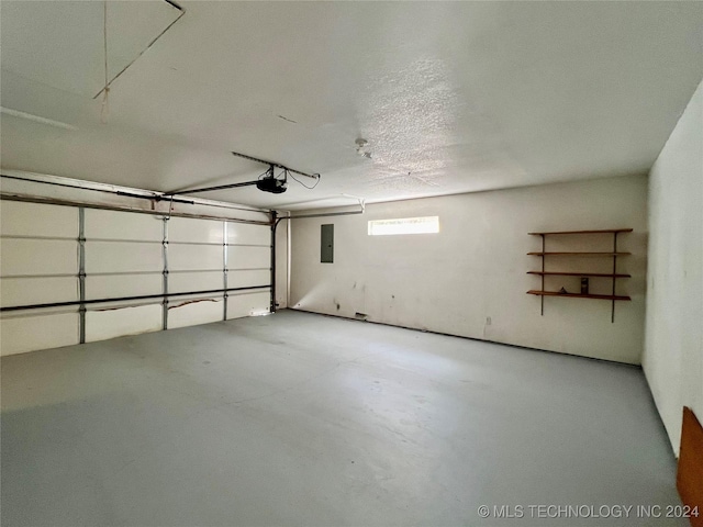 garage with a garage door opener and electric panel